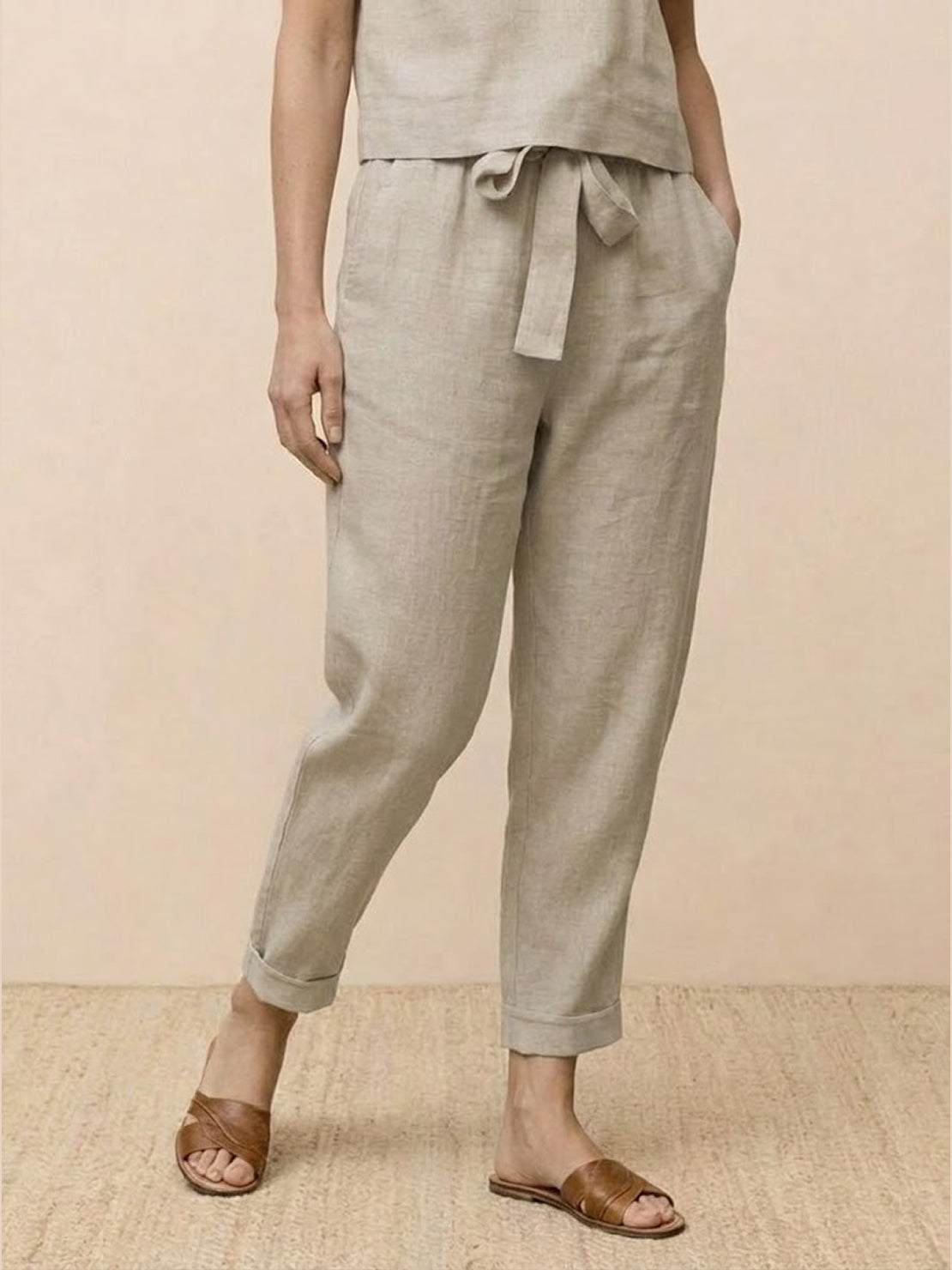 woman wearing relaxed cotton linen set with short sleeves and straight-leg pants in monochrome tones