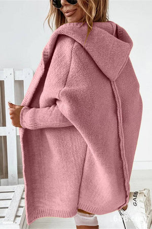Pink warm oversized hooded cardigan with relaxed fit and soft knit fabric worn by woman
