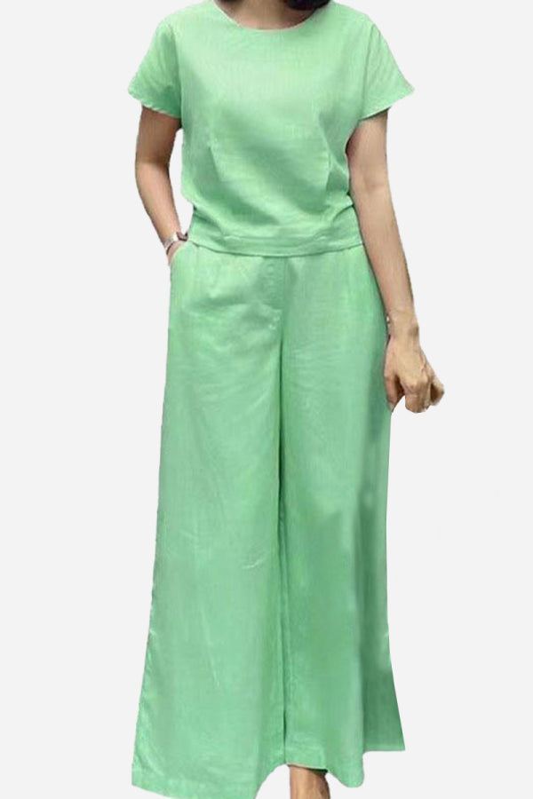 Woman wearing a green short-sleeved bell pants two-piece set with loose fit and wide-leg pants