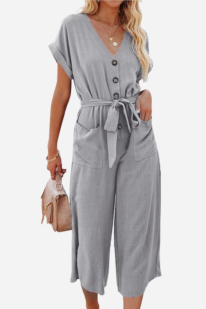 Gray V-neck lace-up pocket jumpsuit with tie belt and wide cropped legs for a feminine casual look