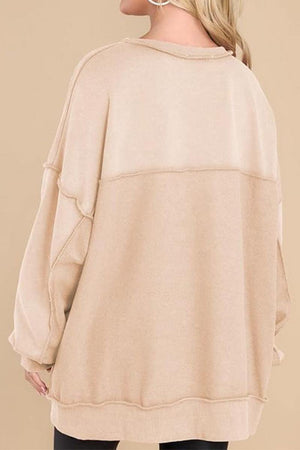woman wearing beige oversized urban sweatshirt back view lightweight casual streetwear