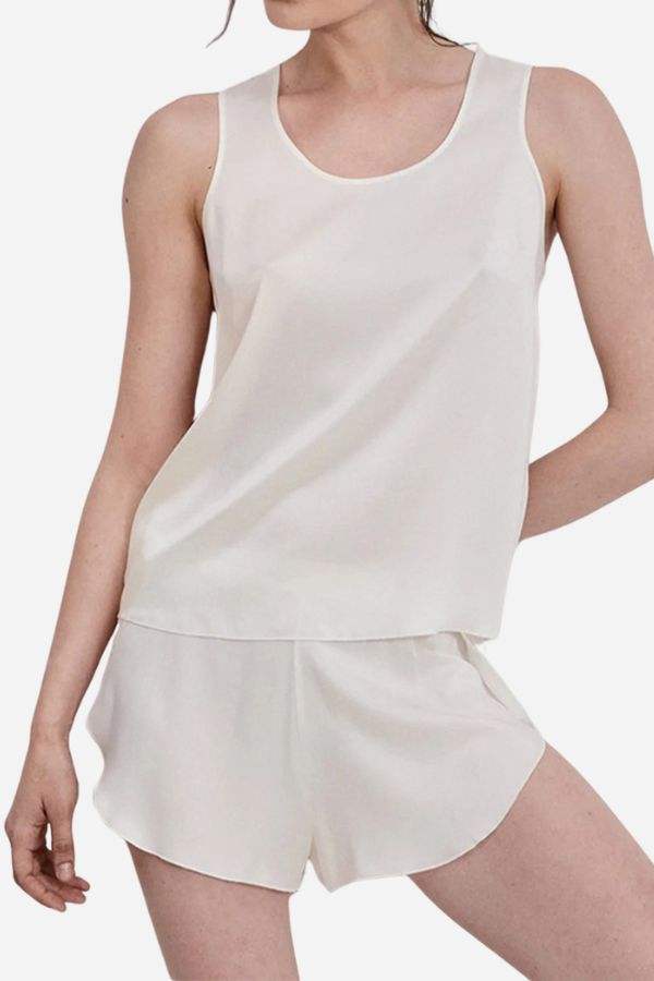 Woman wearing a cream-colored Mulberry Silk Tank & Shorts Set, lightweight and breathable sleepwear.
