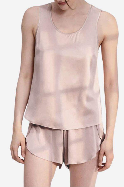 Woman wearing a light pink Mulberry Silk Tank & Shorts Set with a smooth, lightweight texture.
