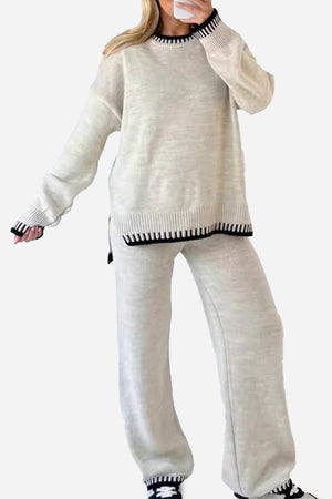 Woman wearing chic contrast stitch travel set with relaxed fit sweater and pants