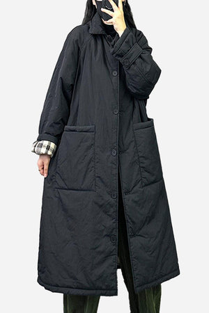 Plus size oversized black windbreaker parka with large pockets and long sleeves worn by model