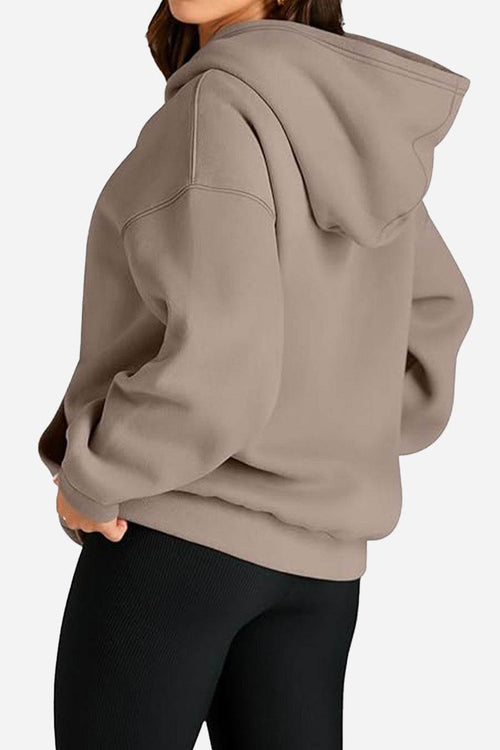 Oversized fleece-lined hoodie in taupe with relaxed fit and hood, cozy travel layering option