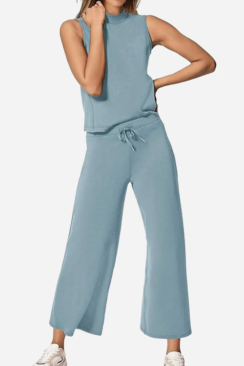Woman wearing light blue cotton chic sleeveless two-piece set with wide-leg pants and sleeveless top