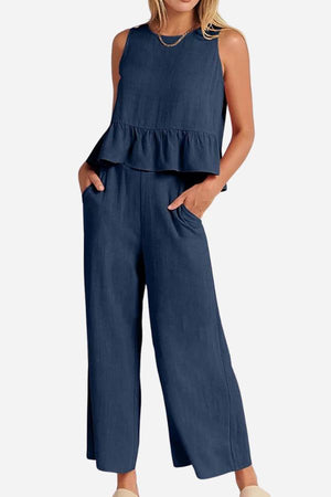 Women's navy linen-like feel set with sleeveless ruffled top and wide-leg pants, lightweight and breathable for travel.