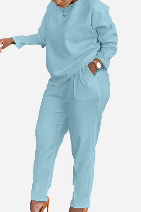 Woman wearing light blue cotton two-piece set vibrant with long sleeves and tapered pants