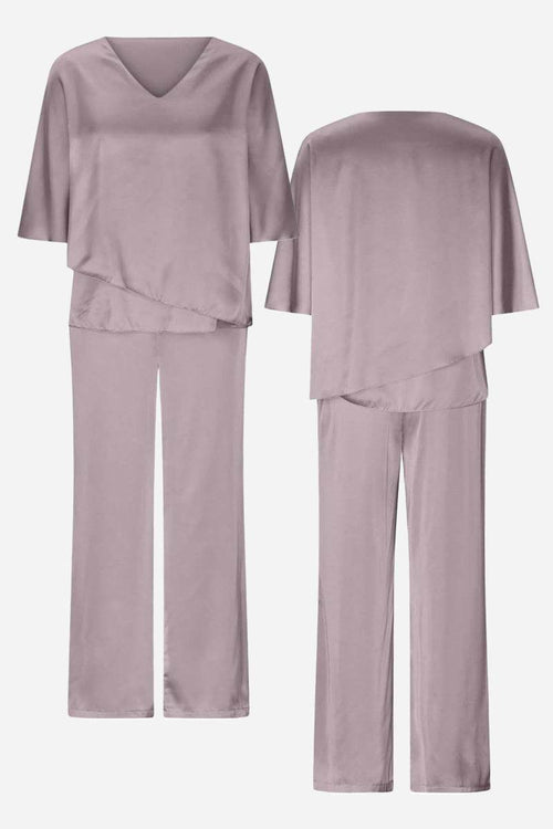 Elegant Layers Two-Piece Set with layered V-neck top and comfortable pants in soft, wrinkle-resistant fabric.