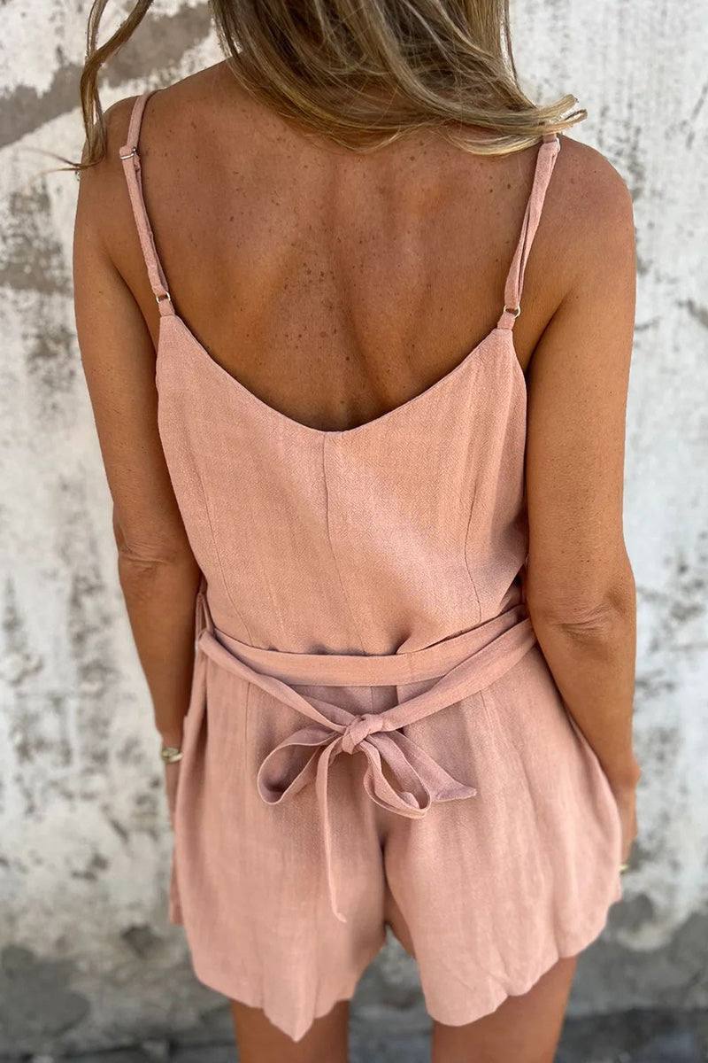 woman wearing pink 100% pure linen breathable natural comfort jumpsuit from the back with adjustable waist tie and thin straps