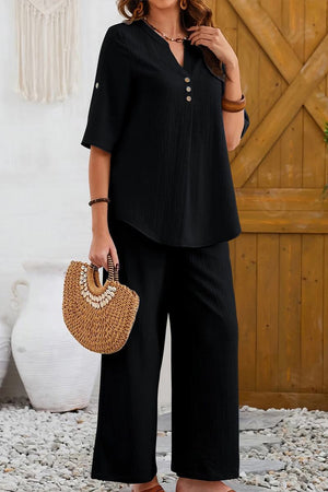 Wrinkle-free black wide leg pants and button-front top set for comfortable, elegant travel wear