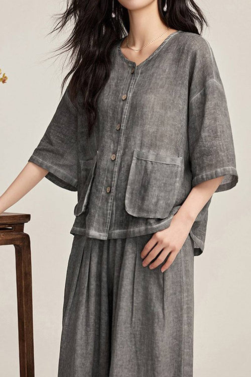 Woman wearing 100% linen stone-washed button-up top and wide-leg pants set in muted grey tones