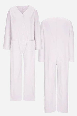 Front and back view of a light lavender relaxed jumpsuit with button-front, long sleeves, and pockets