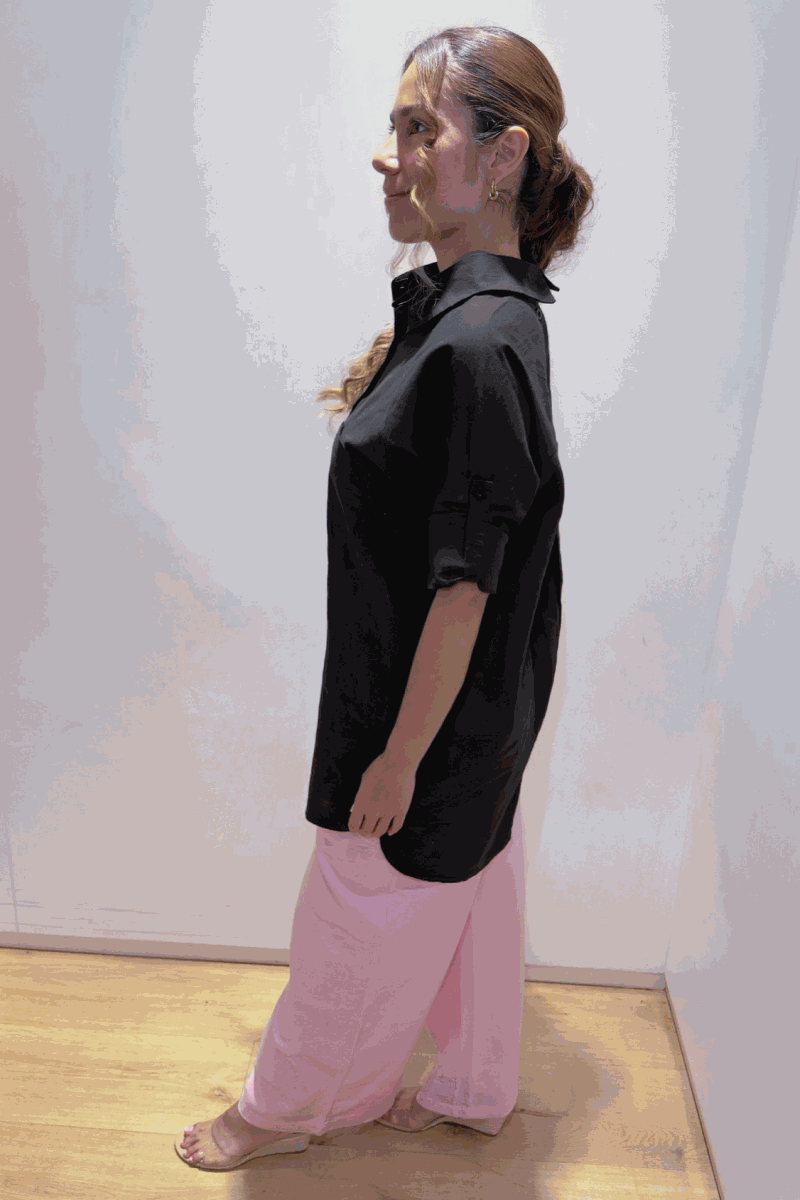Woman wearing oversized black linen-blend shirt and pink palazzo pants from the Oversized Linen Leaved-IN Set, standing indoors.