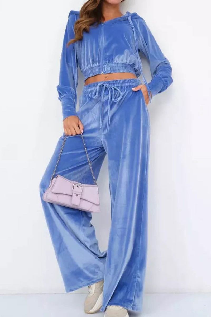 Blue velour tracksuit with cropped hoodie and high-waist wide-leg pants.