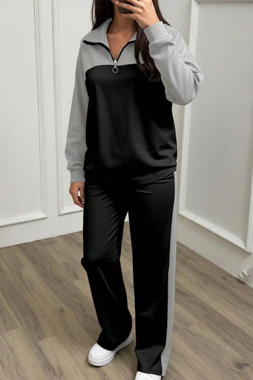 Woman wearing Colorblock Comfort Leisure Set with half-zip top and wide-leg pants in black and gray