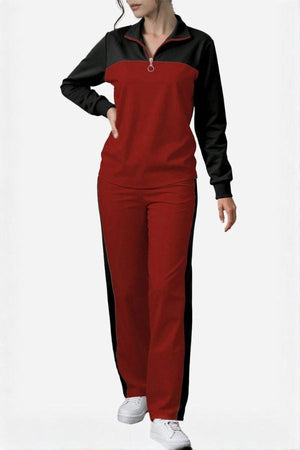 Woman wearing Colorblock Comfort Leisure Set with red and black color-block design, half-zip stand collar top, and wide-leg pants.