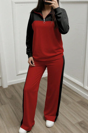 Woman wearing red and black Colorblock Comfort Leisure Set with half-zip stand collar and wide-leg pants in cozy winter-weight fabric
