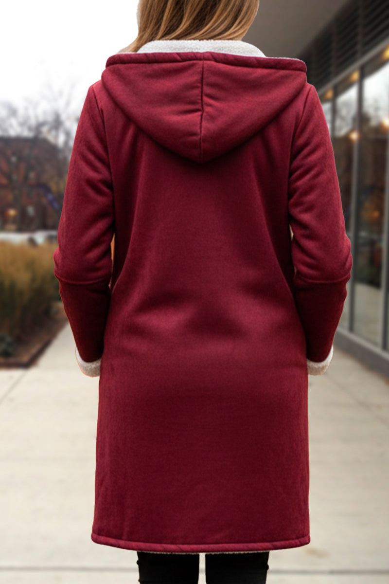 Back view of warm toggle button hooded coat in deep red with sherpa lining on hood worn outdoors