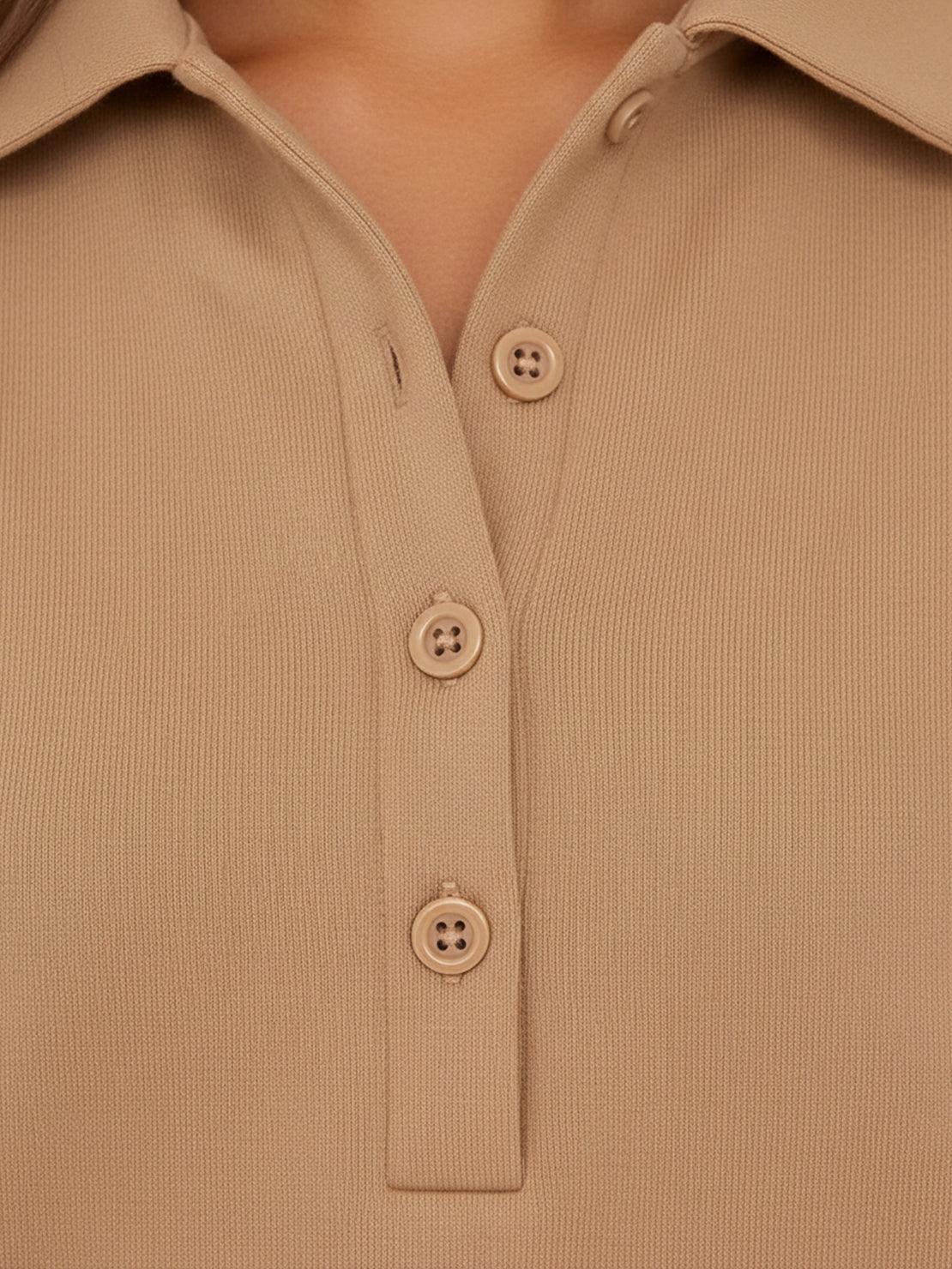 Woman wearing a wrinkle-free polo set with quarter-button top and high-waisted pants