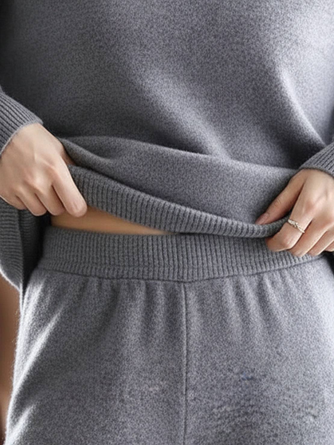 Woman wearing oversized polo knit loungewear set with soft V-neck collar and straight-leg pants