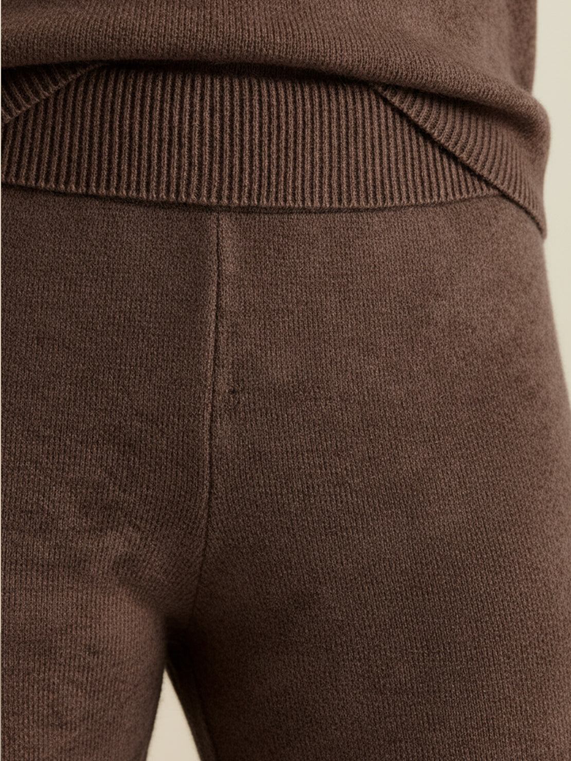 woman wearing oversized polo knit loungewear set with soft V-neck collar and straight-leg pants