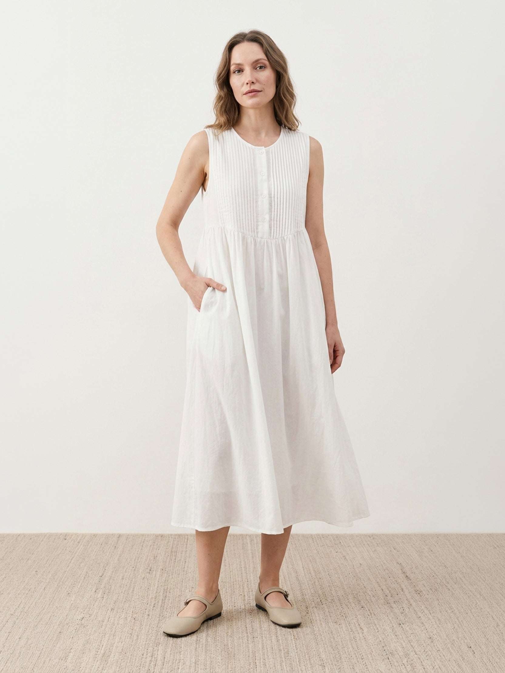 Sleeveless cotton linen pleated midi dress with pintuck bodice and A-line calf-length skirt in relaxed fit
