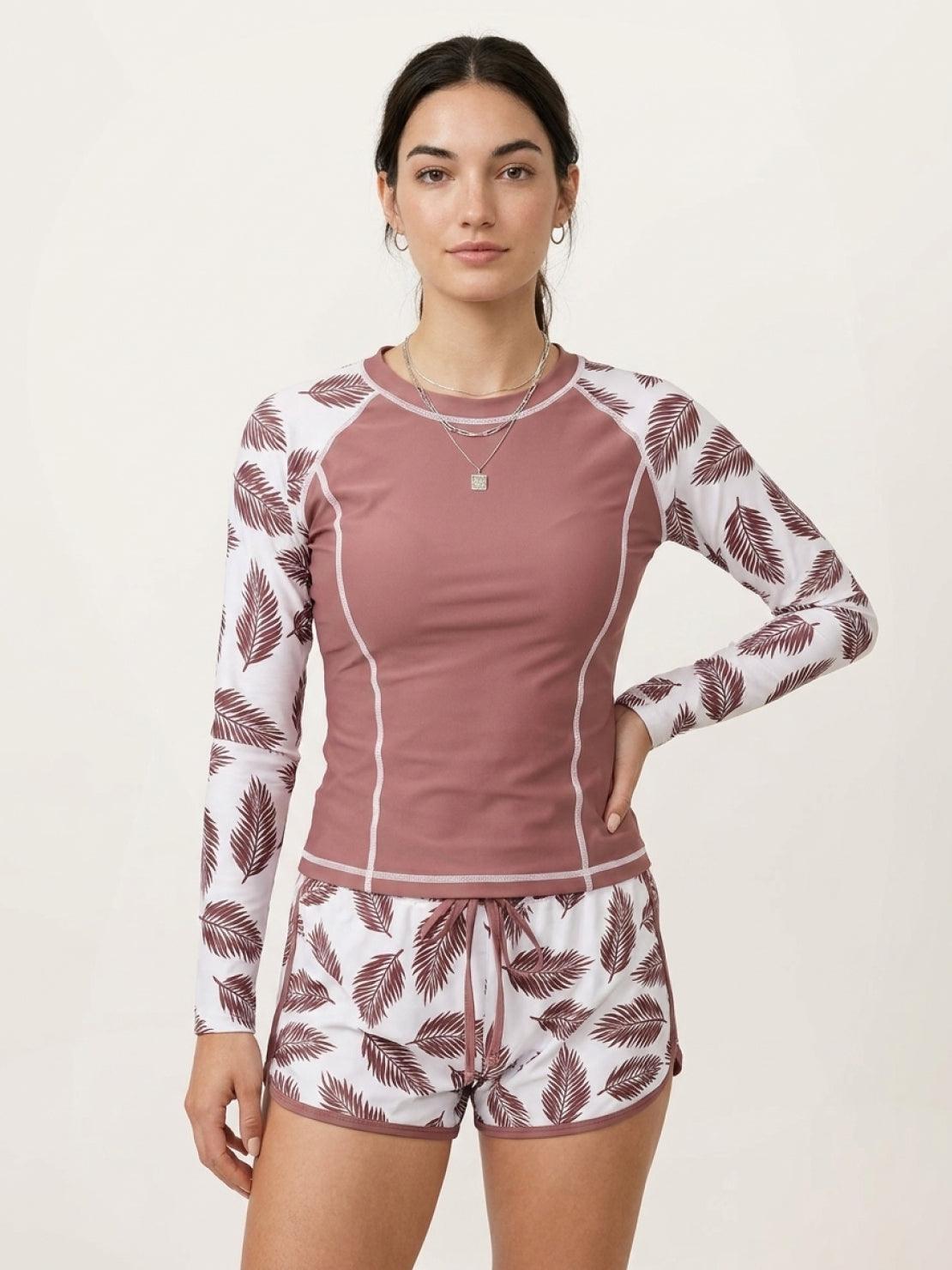 Long-sleeve UV rash guard set with tropical print sleeves and matching swim shorts for sun protection and sporty style