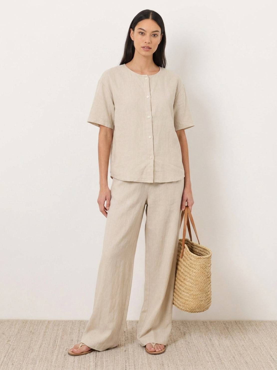 woman wearing navy blue 100% cotton two-piece set with button-front top and wide-leg pants