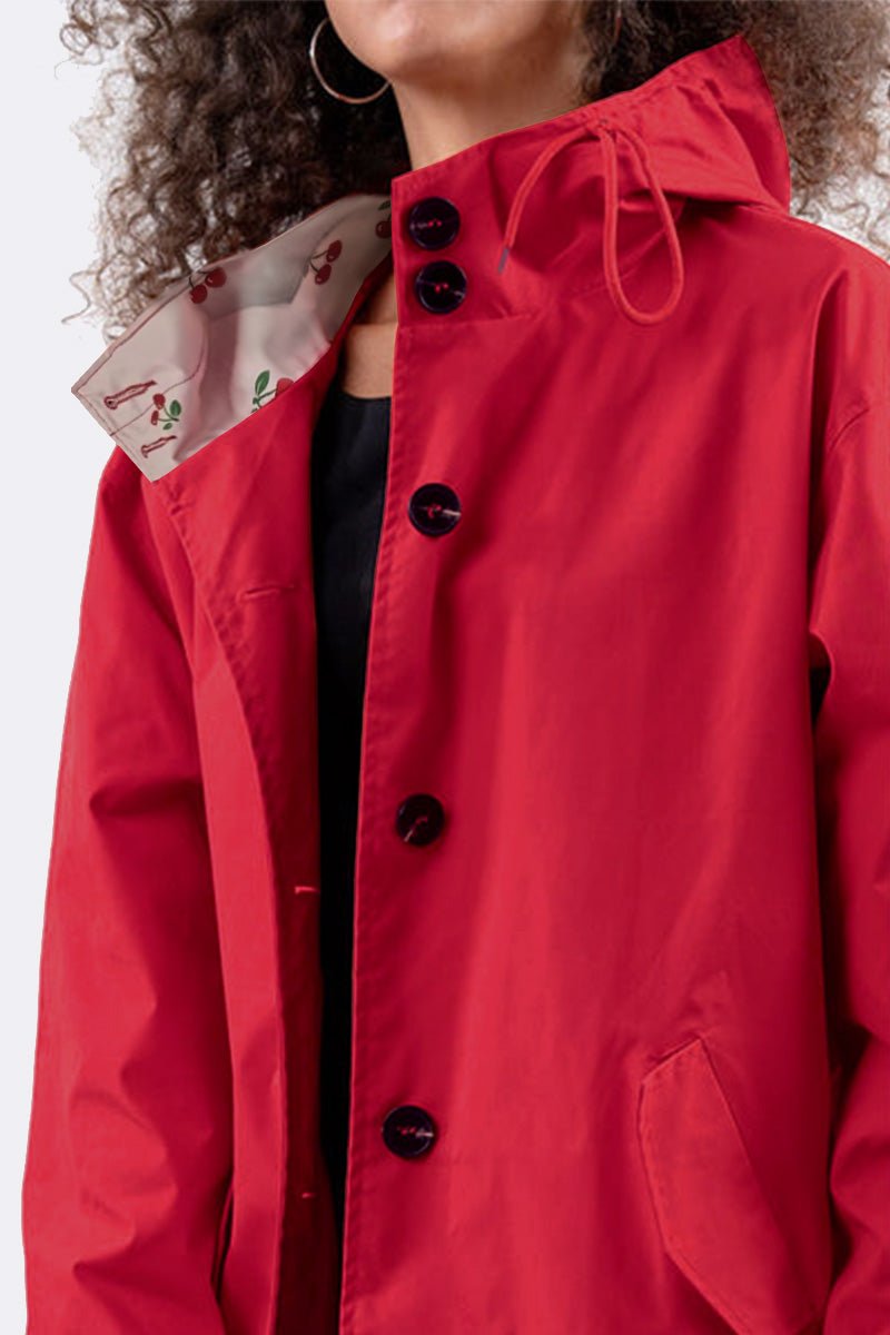 Red water resistant oversized hooded windbreaker jacket with black buttons and floral inner lining