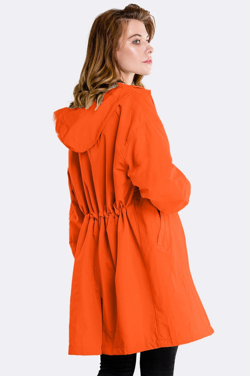Orange oversized water-resistant windbreaker jacket with hood and adjustable waist, rear view.