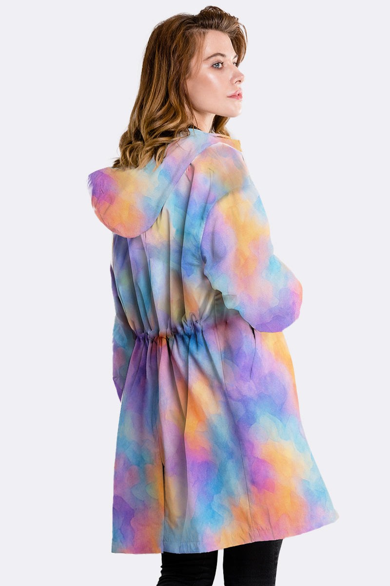 Colorful water-resistant windbreaker jacket with oversized fit and hood worn by woman from back side