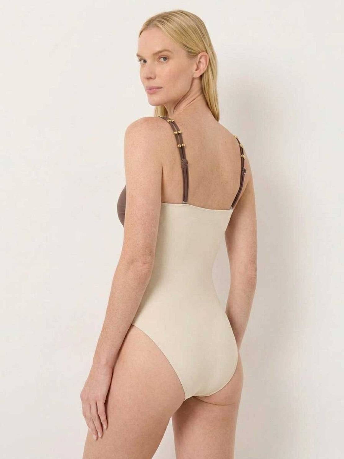 Gold-detail cutout one-piece swimsuit with ruched panels and matching midi wrap skirt for beachwear