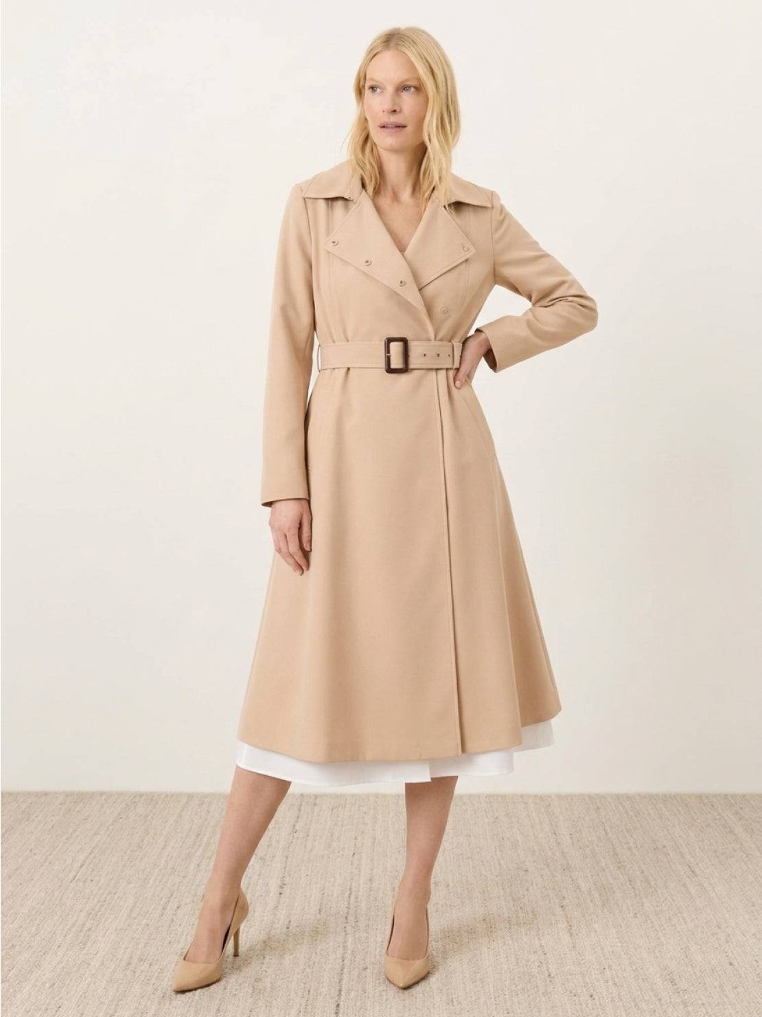 Woman wearing water-repellent A-line hooded raincoat with belt outdoors