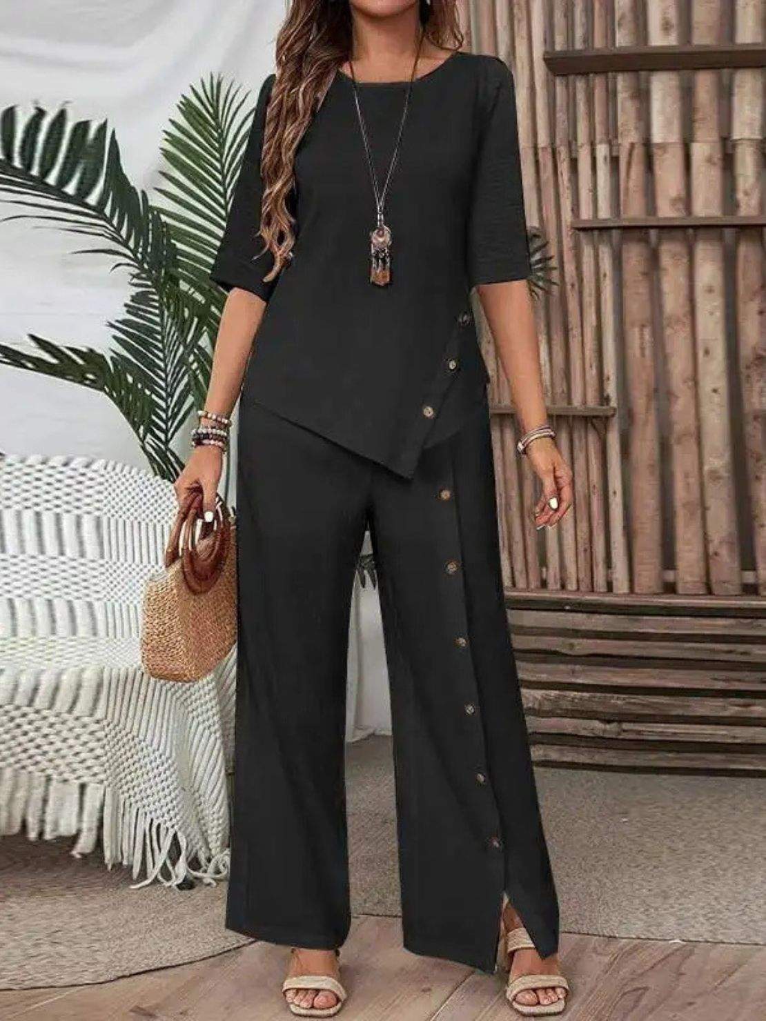 Woman wearing Asymmetry Flow Co-ord button-front top and flowing pants with asymmetrical hem in soft fabric