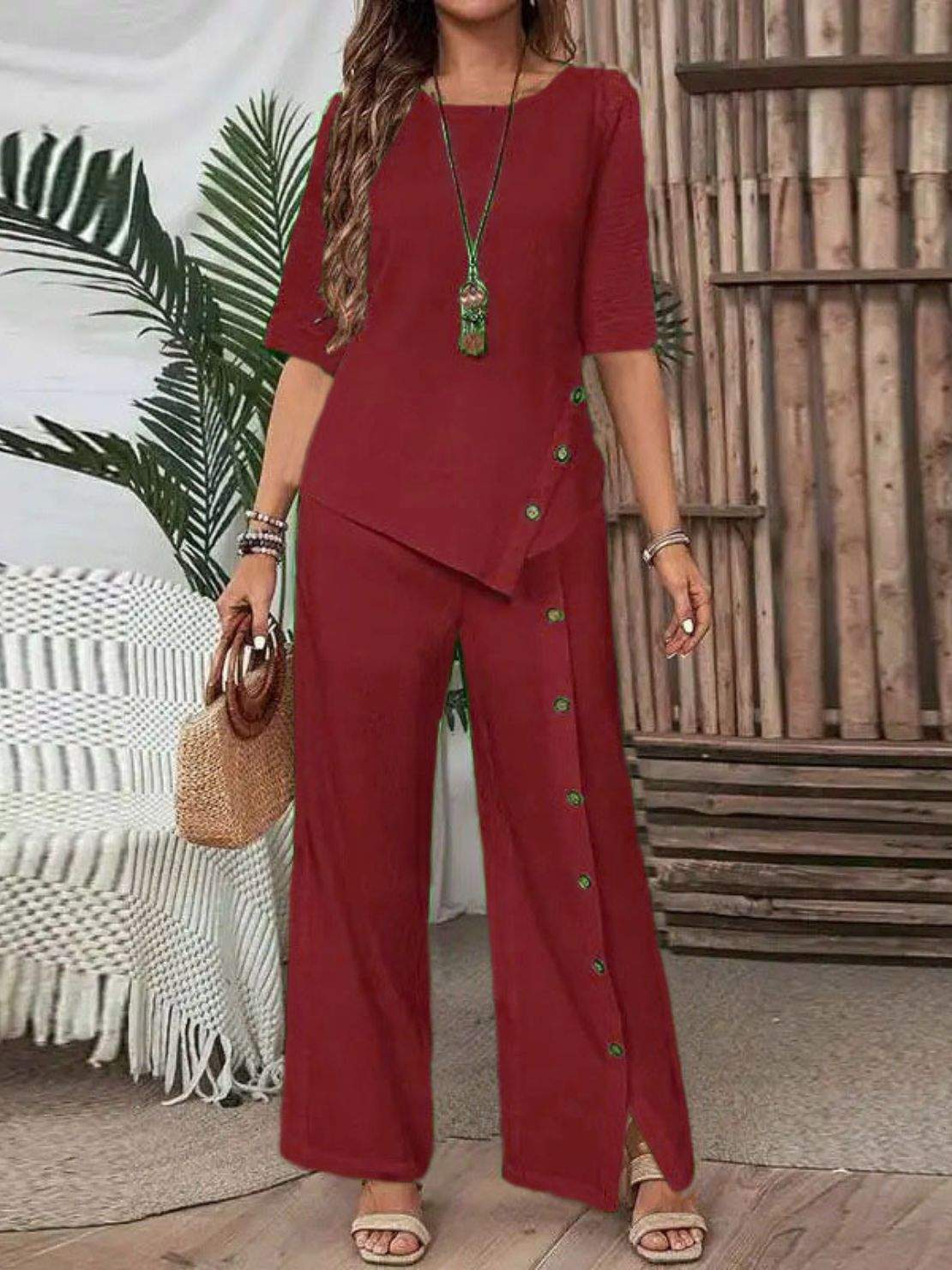 Woman wearing Asymmetry Flow Co-ord with button-front top and flowing pants featuring irregular hem detailing and relaxed silhouette.
