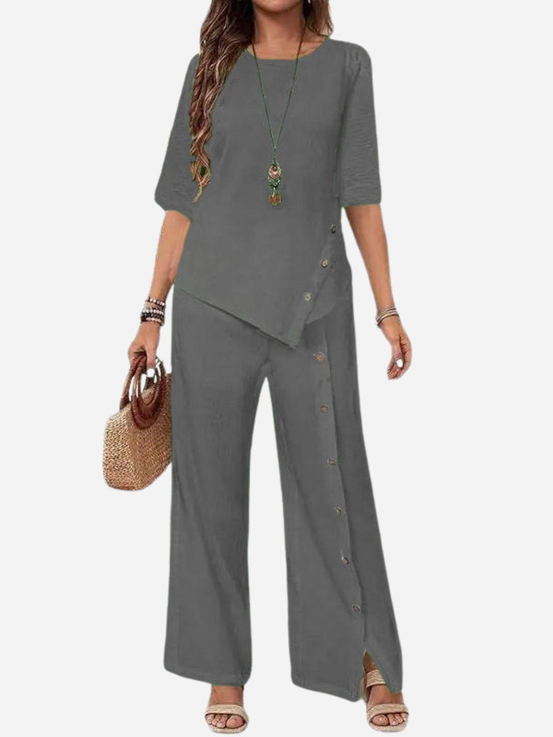 Woman wearing Asymmetry Flow Co-ord with button-front top and flowing asymmetrical hem pants in soft linen-feel fabric.