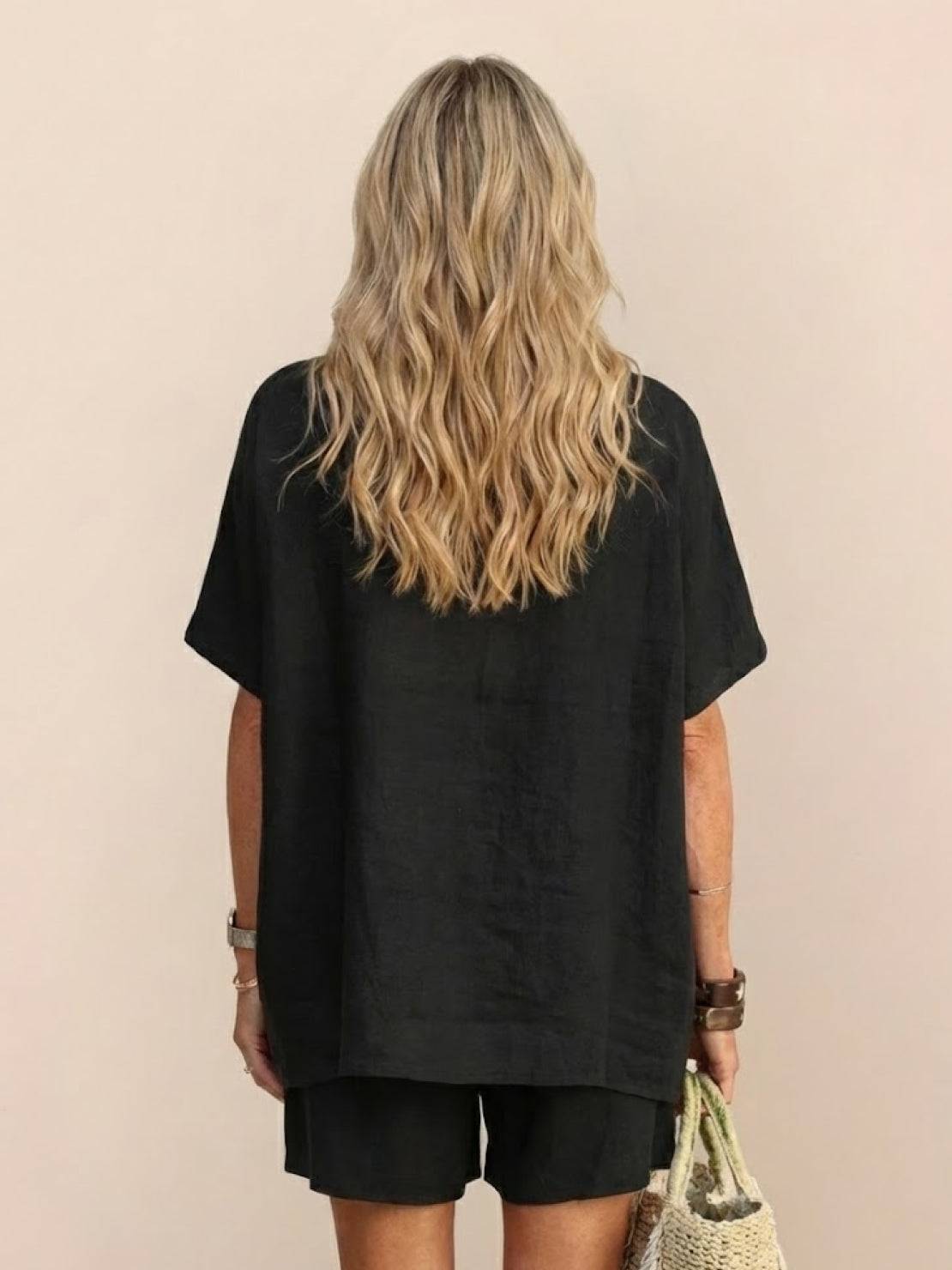 Woman wearing comfy linen-like shirt and shorts two-piece set in light fabric