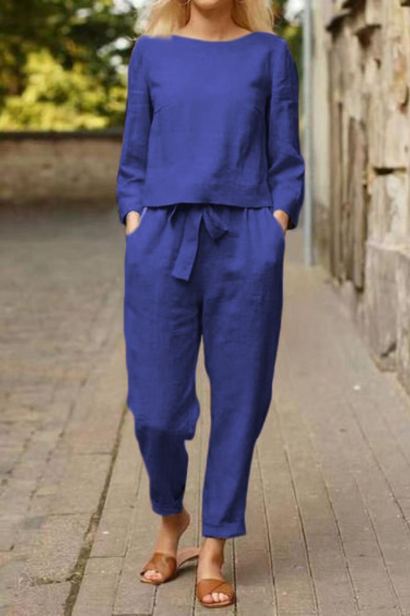 Woman wearing blue cotton-linen monochrome relaxed longline top and wide-leg pants set with pockets and tie waist
