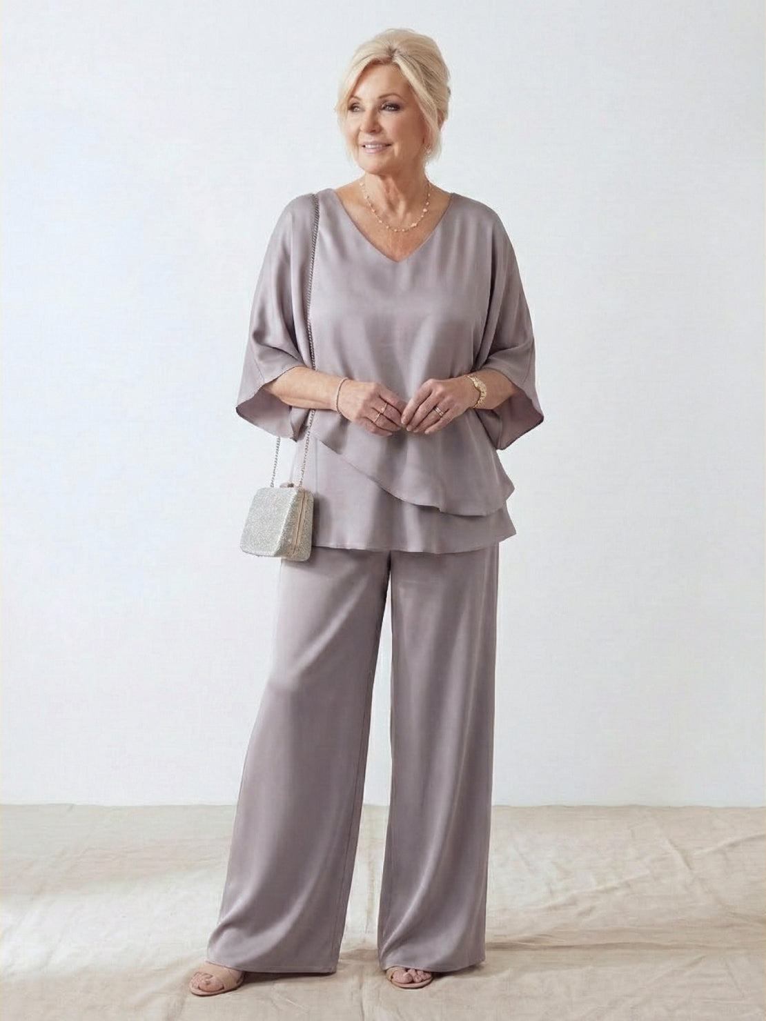 Woman wearing Elegant Layers two-piece set with layered V-neck top and matching pants in a neutral color