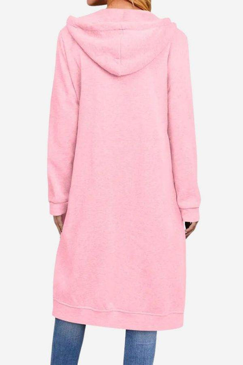 Back view of oversized long zip sweatshirt hoodie in pink with hood and long sleeves worn with jeans