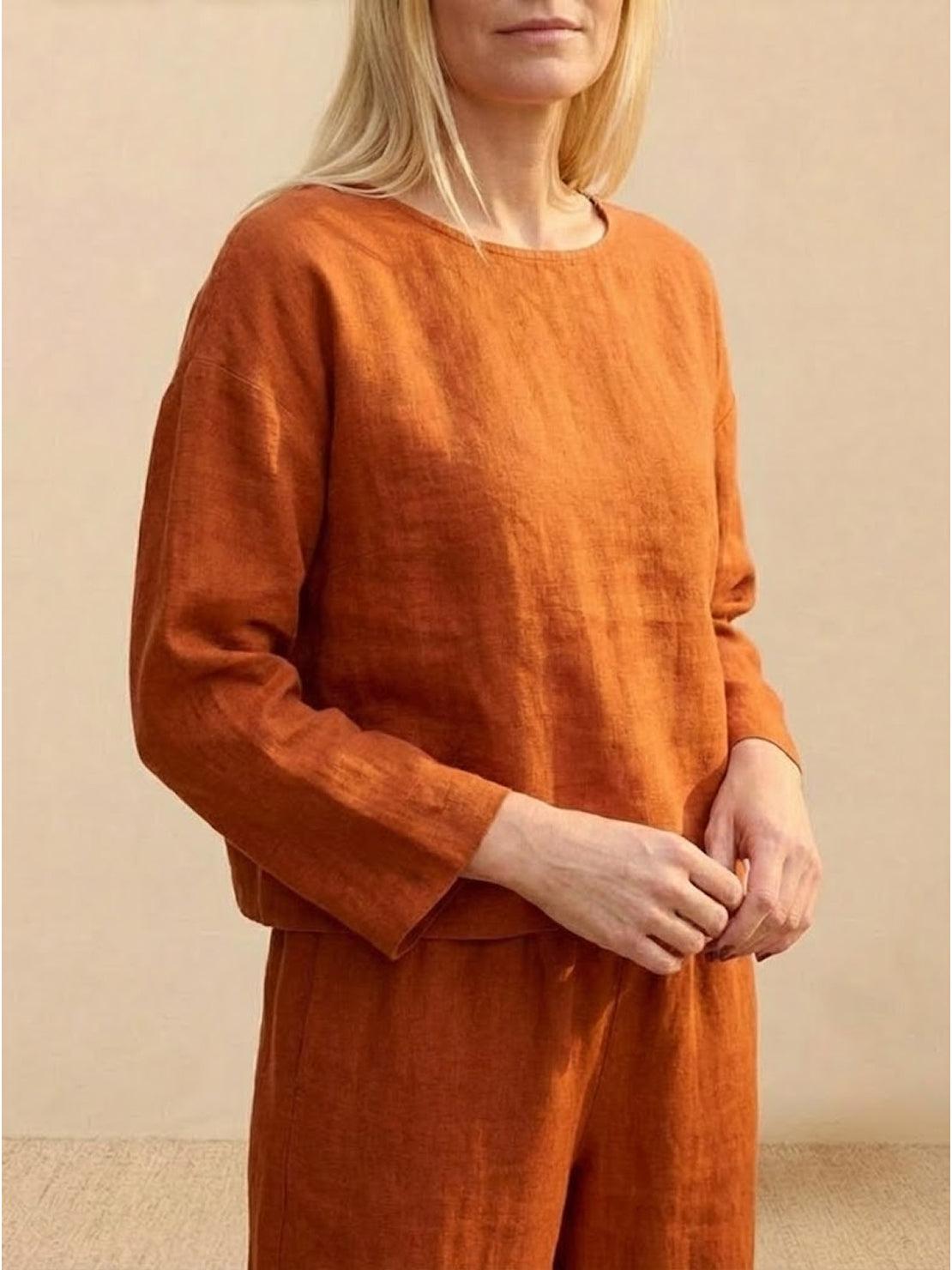 Loose solid color two-piece set in breathable linen-feel fabric, featuring a relaxed fit top and matching wide-leg pants.