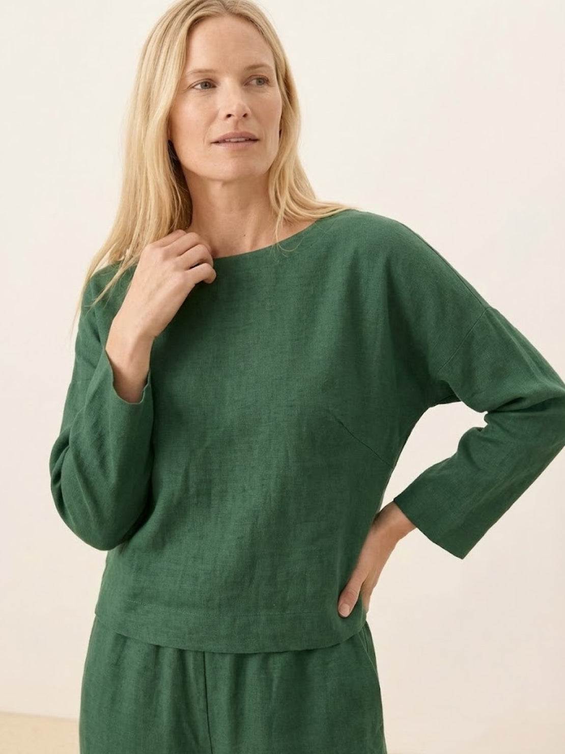 woman wearing loose solid color green long sleeve top and matching pants two-piece set