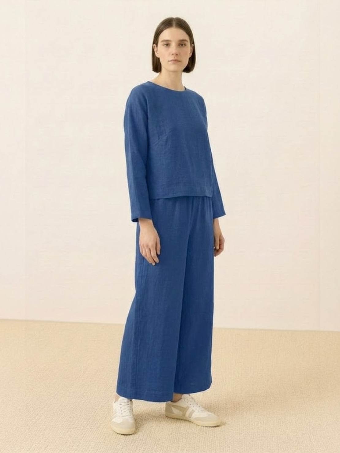 Loose solid color two-piece set in blue with loose fit top and wide-leg pants.