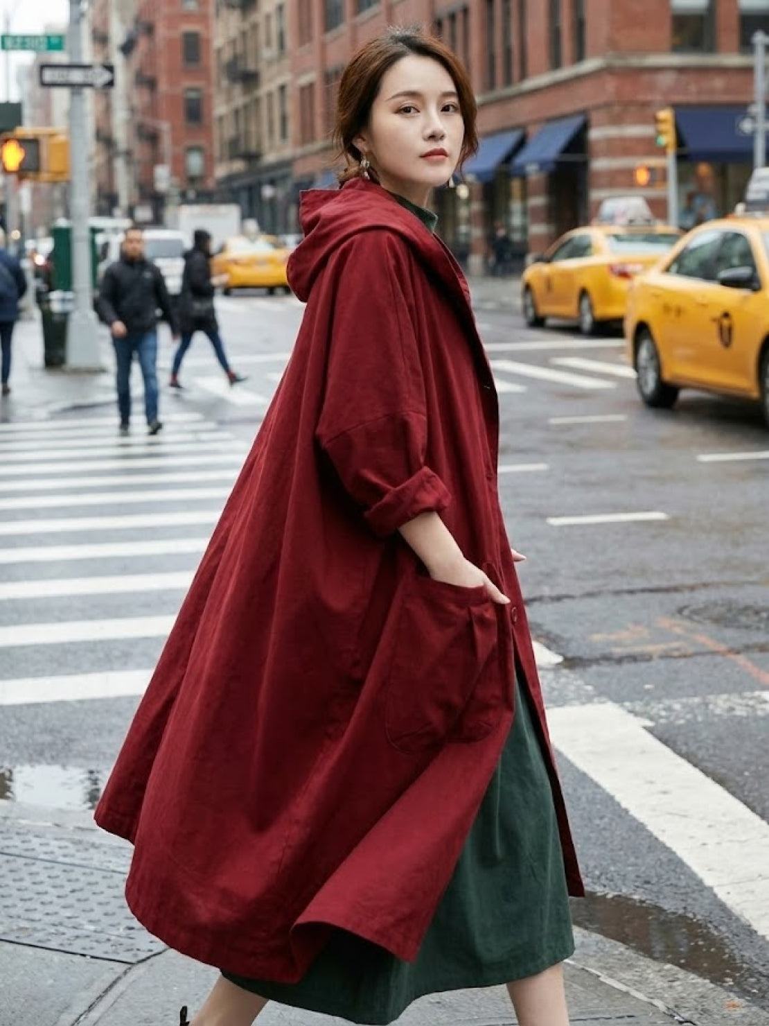 Woman wearing oversized one size fits all water-resistant red windbreaker jacket with waterproof design on city street
