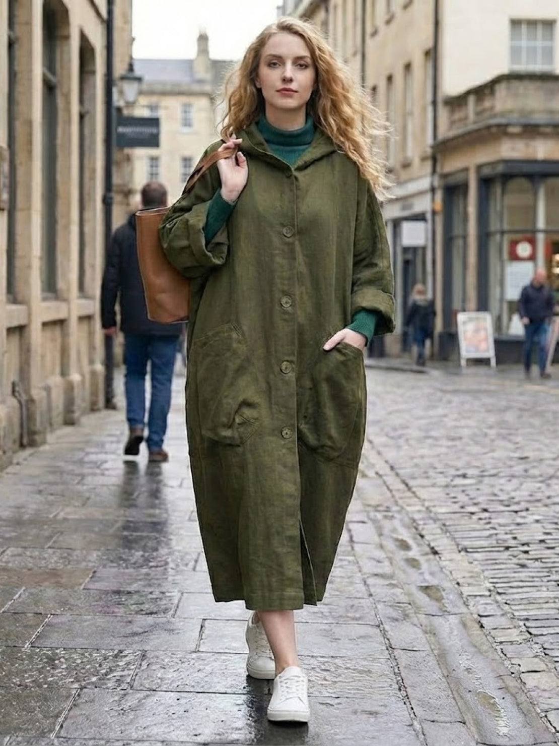 One size fits all oversized water-resistant windbreaker jacket with waterproof design, attached hood, large pockets, and snap-button closure.