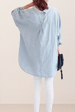 Back view of oversized linen shirt in light blue with relaxed fit and button details