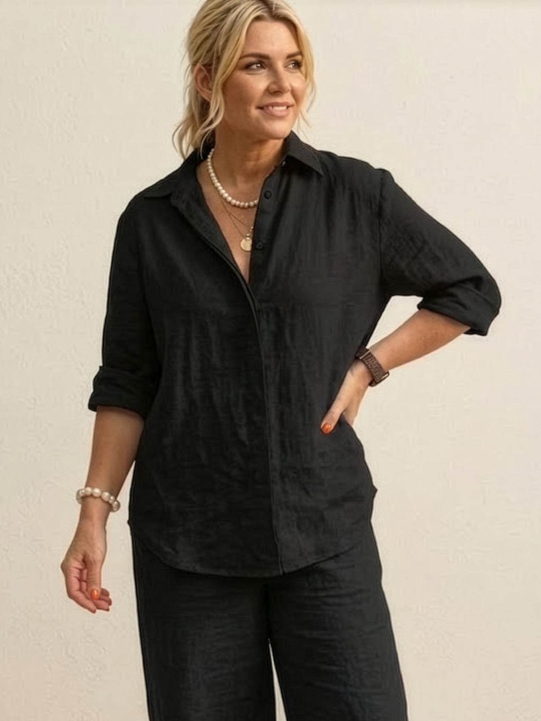 woman wearing oversized 100% cotton black shirt and wide-leg pants co-ord set