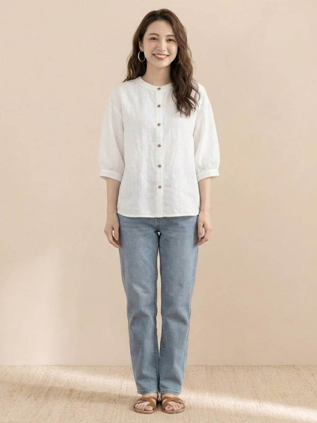 woman wearing relaxed loose breathable linen white blouse with blue jeans